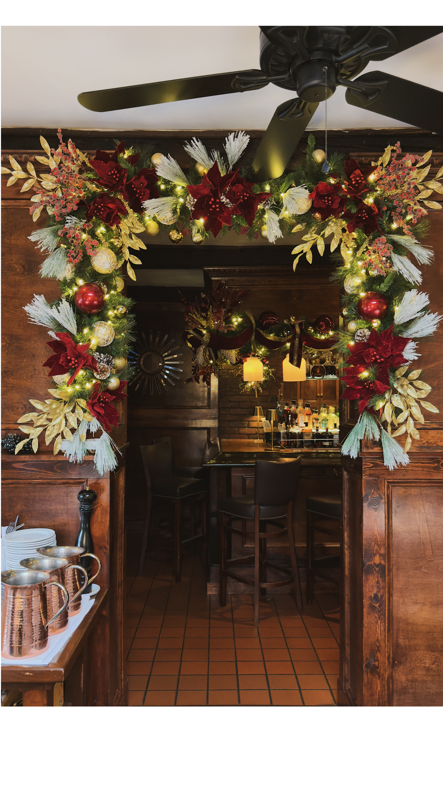Luxury commercial hotel lobby decorated with towering Christmas tree, warm fairy lights, and velvet ribbons