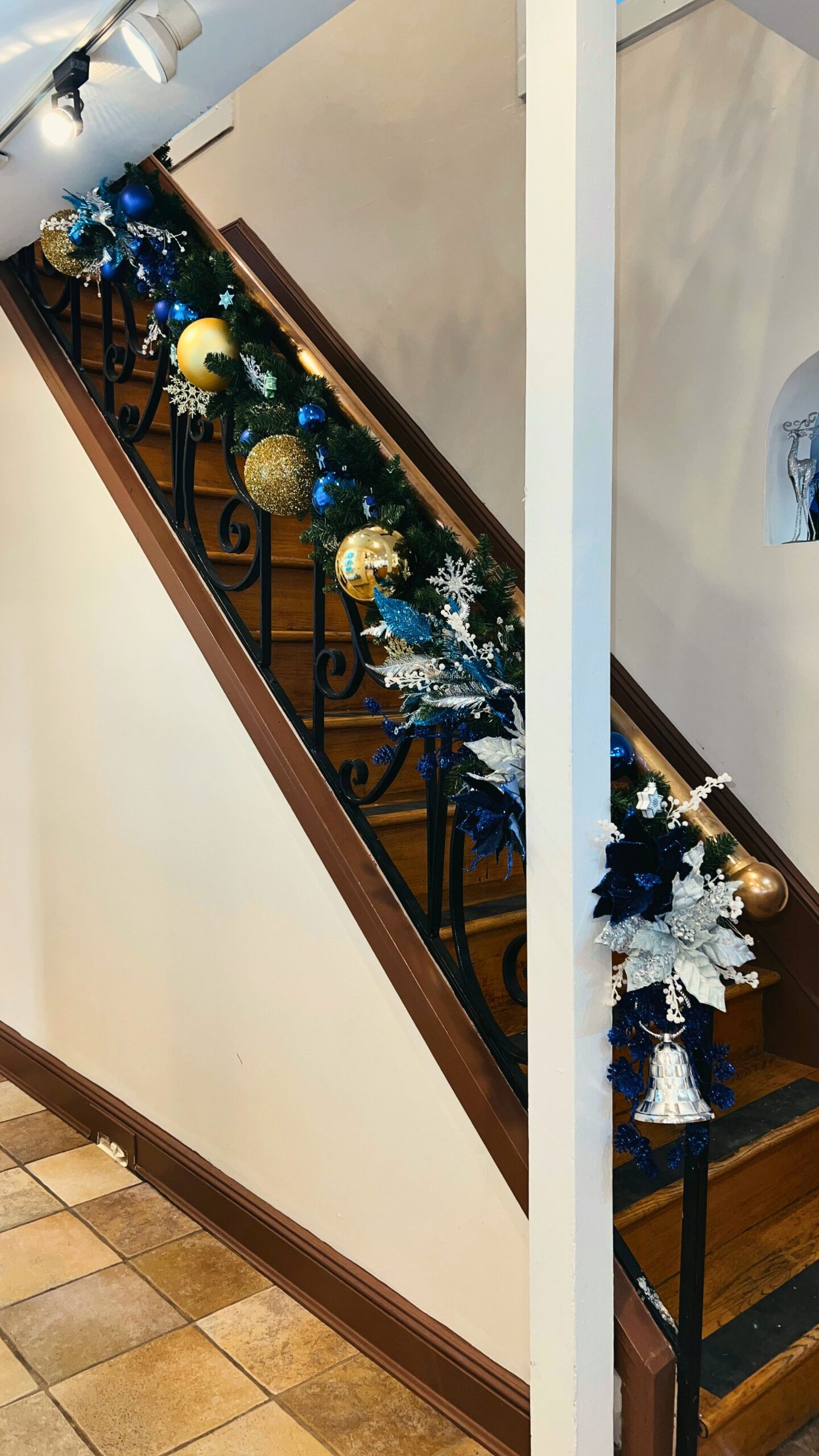 Staircase holiday styling with blue and metallic Hanukkah-inspired accents at Papillon Salon